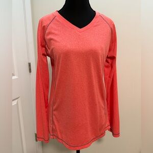 Salmon colored, V-neck, long-sleeve athletic top